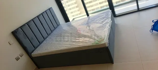 Gray upholstered double bed with mattress - good condition