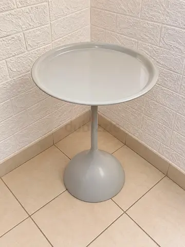 Round light grey tray-top pedestal side table