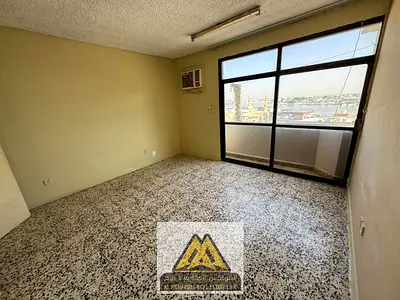 A well-located apartment featuring one bedroom, a separate living room, two bathrooms, and two balconies. Situated next to Nesto Hypermarket, it offer