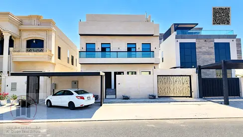 Villa for sale in Al-Aliya, Ajman. Features 5 master bedrooms, a majlis, 3 living areas, a maid’s room, and a roof terrace. Freehold ownership.