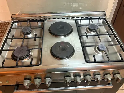 Cooking range with gas plus hot plates