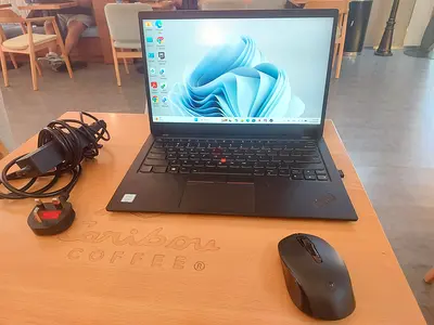 Lenovo ThinkPad X1 Carbon (Windows 11) with charger and wireless mouse