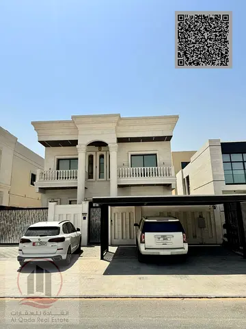 Villa for sale in Al-Aliya, Ajman. Features 5 master bedrooms, a majlis, 3 living areas, a maid’s room, and a roof terrace. Freehold ownership.