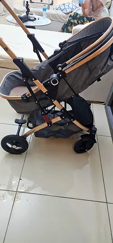 Lightweight grey pram stroller with adjustable handle and storage basket