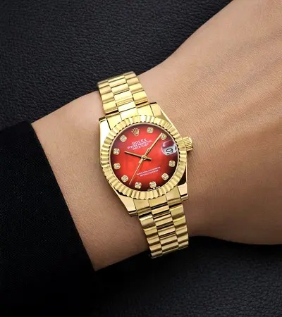 Gold-tone women's wristwatch with red sunburst dial and diamond markers