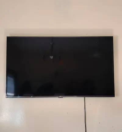 55-inch LED TV wall-mounted in good working condition