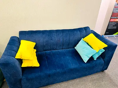 Blue 3-seater velvet sofa with accent cushions - good condition
