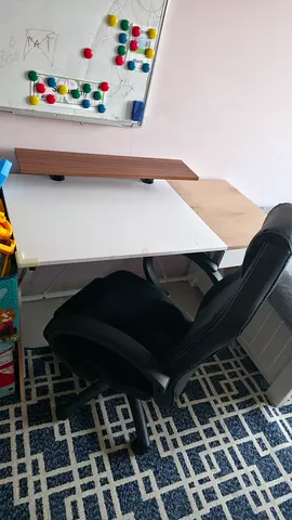 Study desk with ergonomic black chair and storage drawer