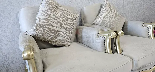 Pair of ornate silver sofa wooden armrests with grey upholstery and wooden bootleg - great condition