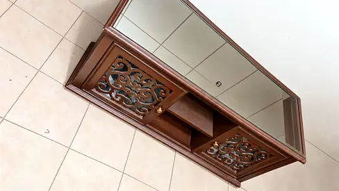 Dark wood-finish cabinet with decorative doors