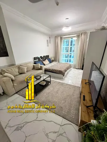 Furnished studio with a separate kitchen and an open view – Oasis Towers, Al Rashidiya 1, Ajman – available for monthly rent.