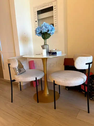 Small round gold bistro table with four upholstered stools