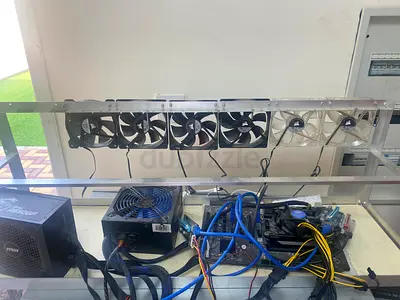 Open-frame GPU mining rig with multiple fans and PSU (used)
