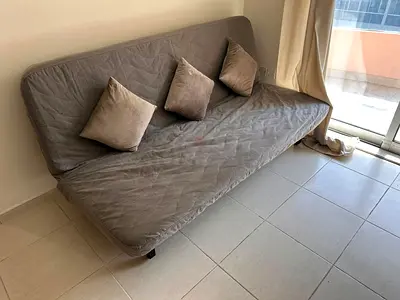 Grey fabric futon sofa bed with 3 cushions - good condition