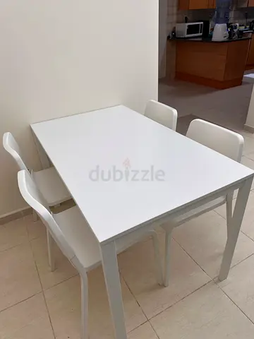 White dining table with 4 chairs - good condition (only 6 months old)
