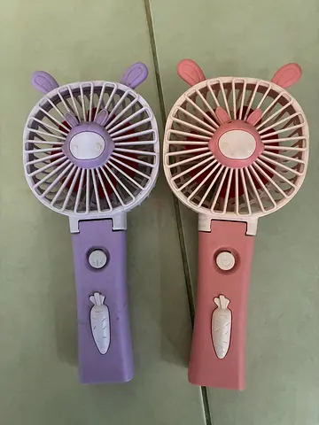 Set of 2 Portable Handheld Rechargeable Fans - Pink & Purple for free