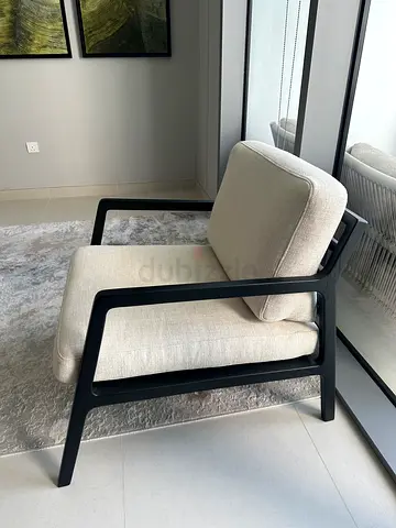Modern cream upholstered lounge chair with black metal frames