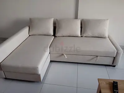 Light beige L-shaped sectional sofa with storage - good condition