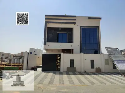 Villa for sale in Ajman, Al Helio area. 5 master bedrooms, majlis, living room, and maid's room. Bank financing available.