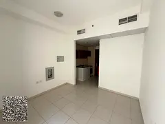 Studio for rent in Smart Tower, Al Amra area, Ajman. The unit features a separate kitchen, a balcony
