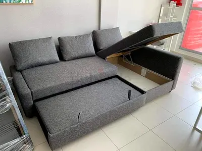 Grey fabric sofa with storage and pull-out bed - good condition