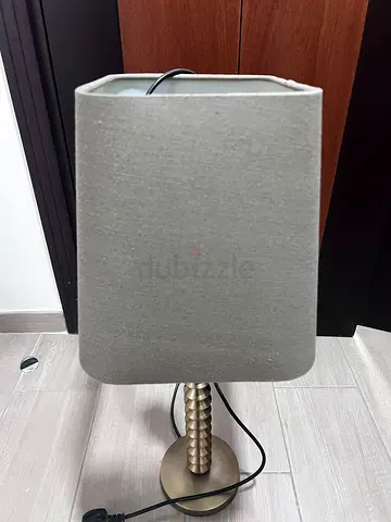 Simple brass table lamp with grey fabric shade