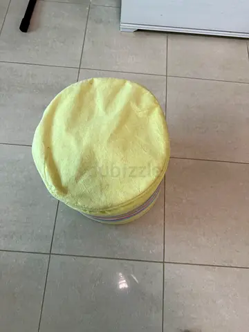 Small round padded stool/ottoman with removable cover