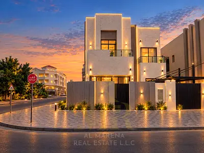 Corner villa for sale in Al Rawda 2, featuring two floors and a roof terrace. It boasts high-end fi