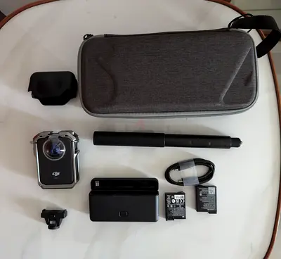 DJI Action Camera + accessories kit (case, batteries, charger, pole) - good condition