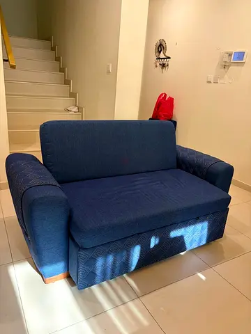 Compact blue two-seater sofa bed (good condition)