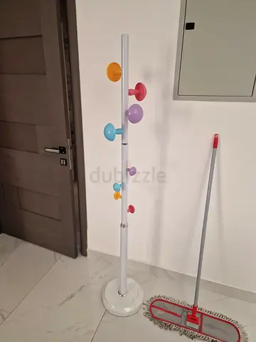 White freestanding coat rack with colorful hooks - good condition