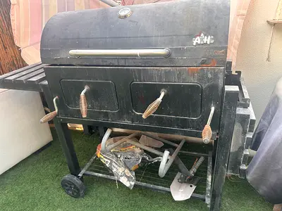 Used charcoal barbecue grill/smoker with side shelf and wheels