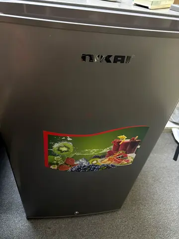 Compact single-door mini fridge in good working condition