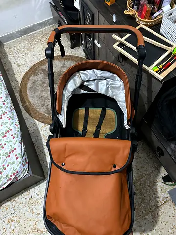 Brown leather-look baby stroller/pram in good condition