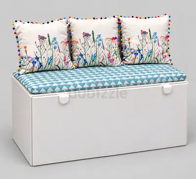 White storage bench with cushioned seat and floral pillows