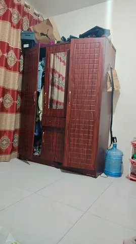 Three-door wooden wardrobe with mirror — good condition