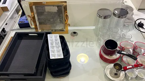 Mixed kitchen serving set: trays, glass canisters, cups and small cookware