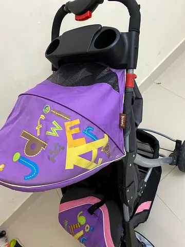 Purple baby stroller with storage and cup holder - gently used