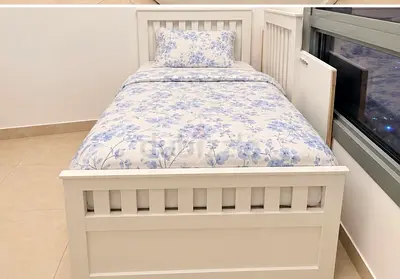 White single bed with storage capacity