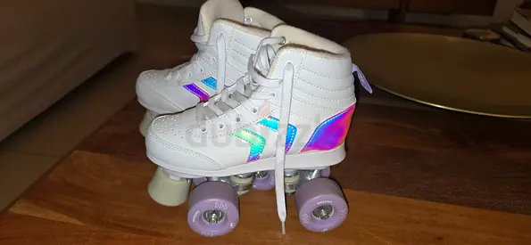 White high-top quad roller skates with iridescent accents - women’s/kids size