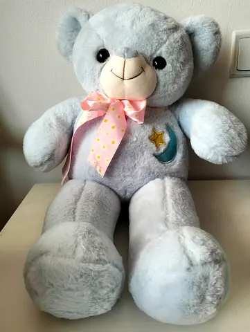 Large light-blue plush teddy bear with ribbon
