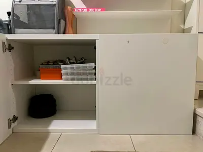 White low storage cabinet with push out door - good condition