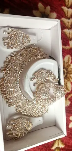 Gold-tone crystal bridal necklace set with matching earrings and tikka