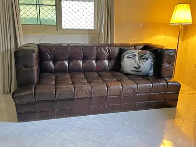 Dark brown tufted leather 3-seater sofa in good used condition