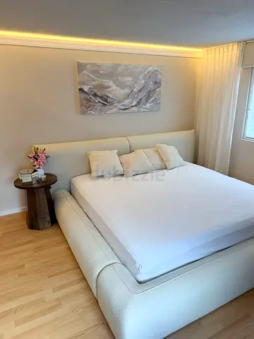 Modern upholstered king bed with headboard — cream fabric