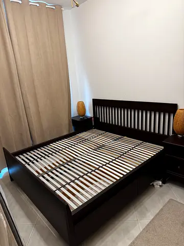 Queen-size wooden bed frame with slatted base — dark finish