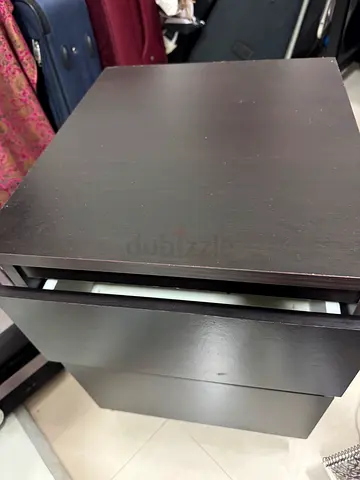 Pair of dark wood bedside nightstands with drawers