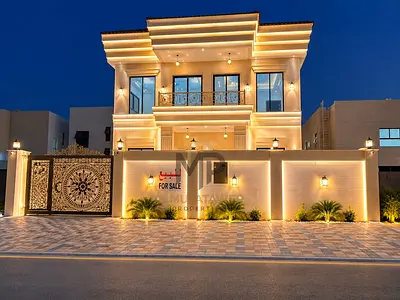 A distinctive villa for sale in Al Zahiyah area, Ajman, featuring 4 bedrooms, a majlis, 2 living rooms, and a maid's room, with central air conditioni