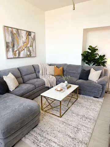 Large L-shaped grey fabric sofa with chaise with Coffee table