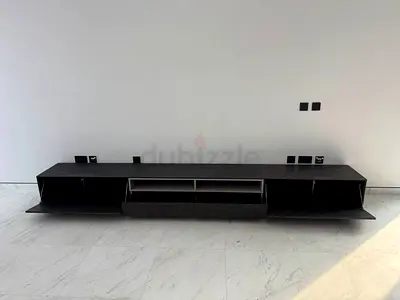 Low modern TV entertainment unit / media console in dark wood.
